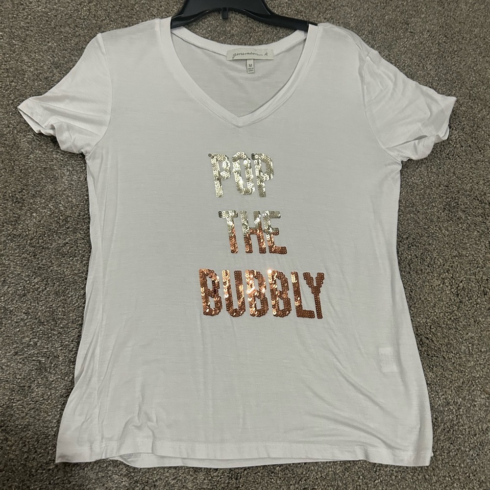 New Year’s Eve/party shirt. V neck. White. Worn once. “Pop the bubbly”